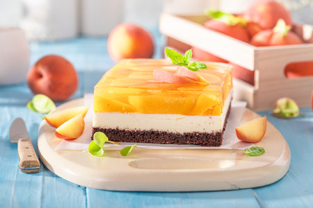 Sweet jelly peach cheesecake made with jelly, fruits and foam. Peach cheesecake with cocoa.の写真素材