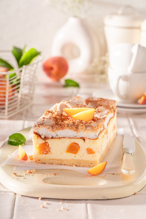 Delicious and tasty peach cheesecake served in the kitchen on the counter. Peach cheesecake with cocoa.の写真素材