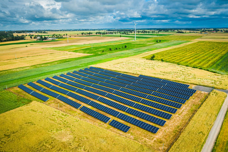 Flying above of solar panels on field in summer, Poland