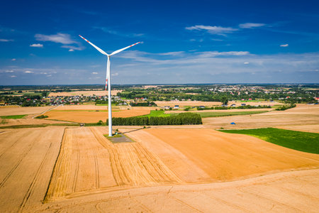 Wind turbines on the field during harvest, Polandの写真素材