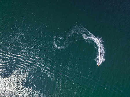 Aerial view of man riding a jet ski on Baltic sea. Recreation on the Baltic Sea. Tourism in Poland.