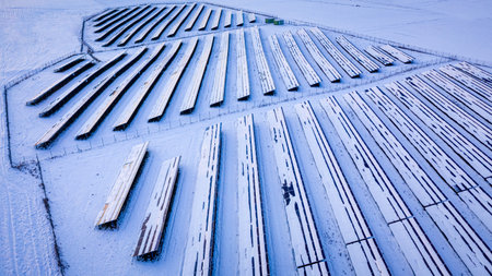 Snowy photovoltaic farm in winter. Alternative energy in Poland, Europe