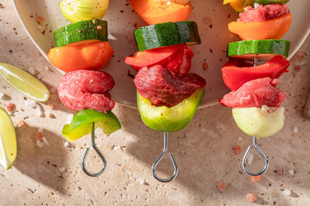 Before roasted fresh skewers as summer snack for bbq. Grilled shashlik with fresh ingredients.の写真素材