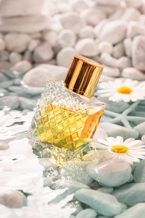Unique golden perfume with a refreshing floral scent. Perfume at sea with white pebbles.