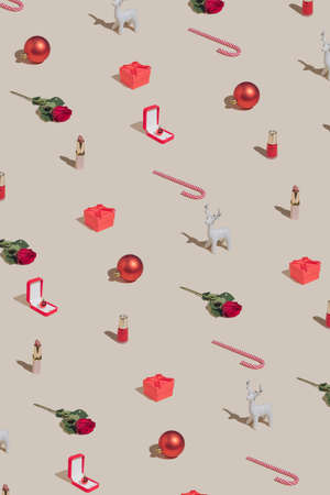 Minimal Holiday pattern made with makeup, Christmas decoration, gift box and roses. Vintage aesthetic style. Creative 2022 New Year party concept.の写真素材