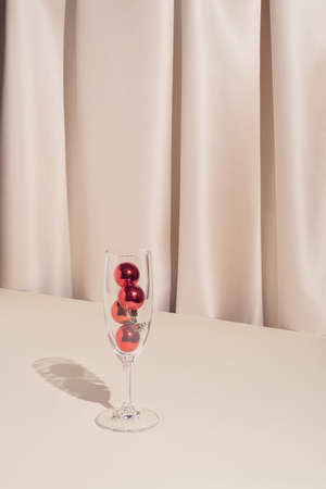 Minimal stylish holiday party composition with red Christmas bauble ornaments. Trendy and elegant vintage concept.の写真素材