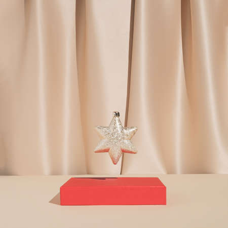Minimal stylish holiday decoration composition with golden Christmas star ornament. Trendy vintage concept.の写真素材