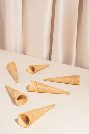 Minimal modern summer composition with six ice cream cones on stylish silk background. Trendy retro concept.の写真素材
