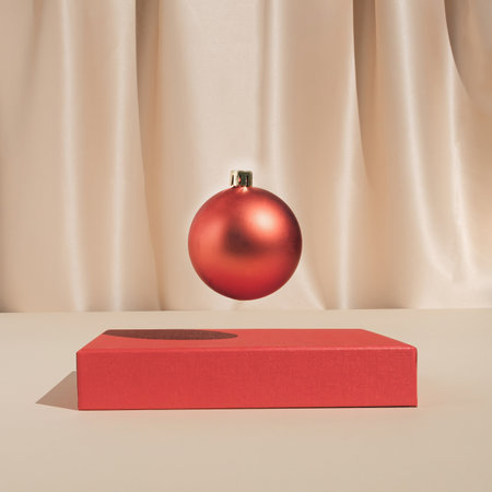 Minimal stylish holiday decoration composition with red Christmas bauble ornament. Trendy vintage concept.の写真素材