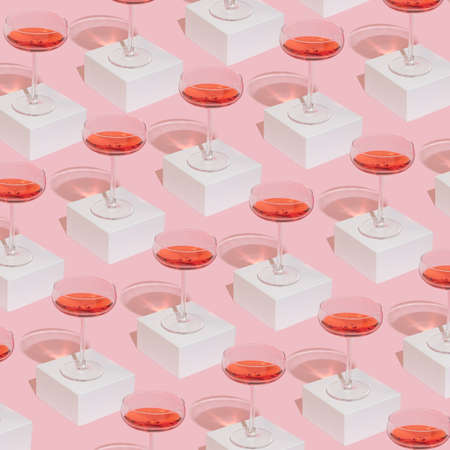 Romantic girly Valentine's Day composition with wine glasses on pastel pink background. Modern minimal pattern.の写真素材