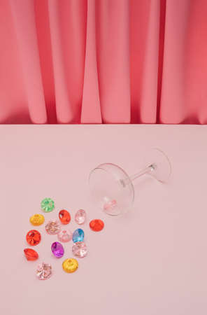 Romantic Valentine or birthday party composition made with wine glass and colorful gemstones. Vibrant and bright modern concept.の写真素材
