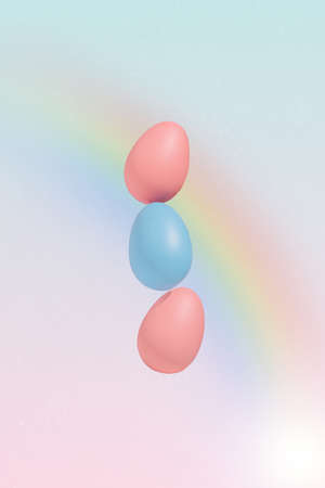 Dreamy pastel Easter concept with pink and blue eggs and colorful rainbow. Modern romantic aesthetic.の写真素材