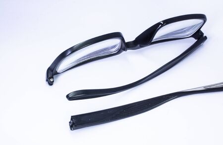 Image of a Broken eyeglass or spectacle or reading glass frame with white background
