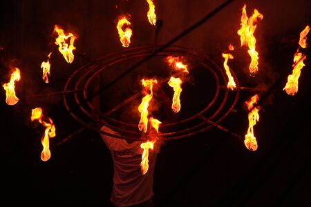 Man entertains the audience with the help of fire during the perehera in srilanka