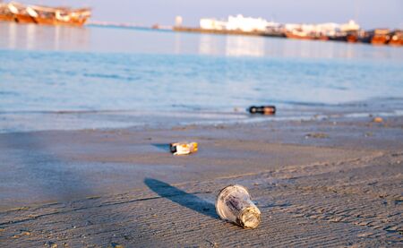 Background image with plastic waste in the shore of harborの写真素材