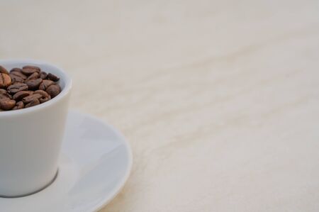 Coffee cup and beans on a white background. Top view with copy space for your text input.の写真素材