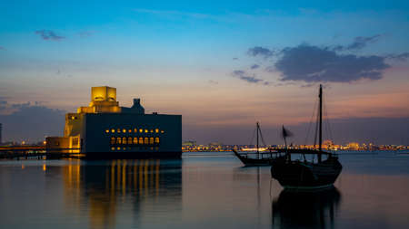 Museum of Islamic Art , Doha,Qatar in daylight exterior view with fountain in foreground and clouds...