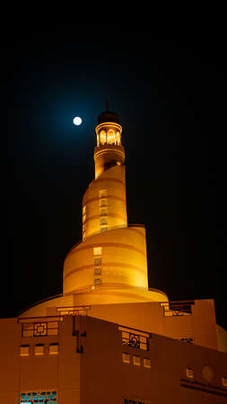Doha,Qatar- 3 March 2020: Background image of Fanar minaret with the full moon background.