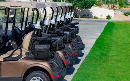 Background image of Golf carts parked on a golf closure in a line.Golf courseの写真素材