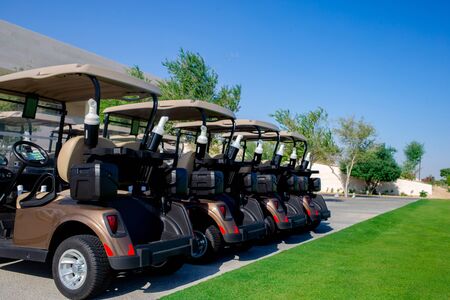 Background image of Golf carts parked on a golf closure in a line.Golf courseの写真素材