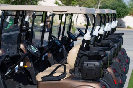 Background image of Golf carts parked on a golf closure in a line.Golf courseの写真素材
