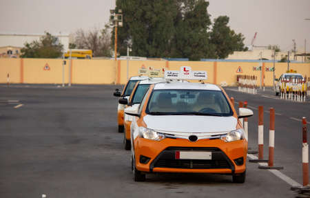 Background image of cars parked in a driving school in a arab country