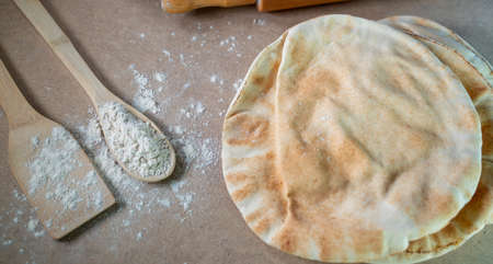 Kuboos or khubz - Arabic bread on a brown table in the kitchen kitchen