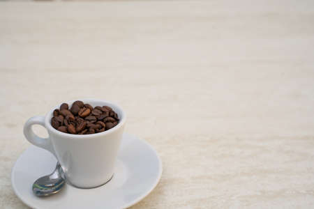 Coffee cup and beans on a white background. Top view with copy space for your text input.