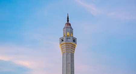 Muslim mosque minaret with dark cloud during the rainy day in Qatar