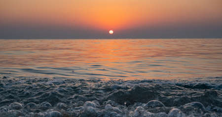 Colorful vibrant ocean beach sunrise during a summer day.の写真素材