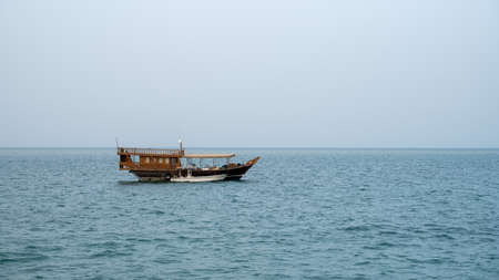Lonely traditional Dhow boats in qatar waters.