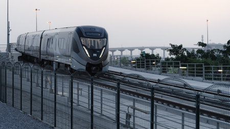 Doha, Qatar- June 06,2022 :Qatar red line metro traveling through the bridge.のeditorial素材