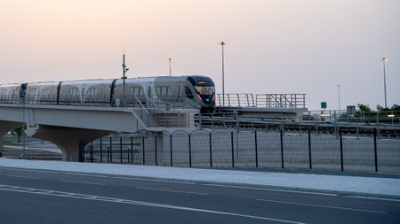 Doha, Qatar- June 06,2022 :Qatar red line metro traveling through the bridge.のeditorial素材