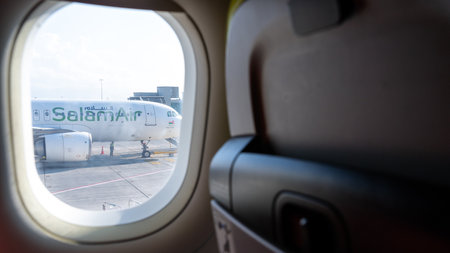 Muscat, oman-November 21,2023 :view of salam airways plane through the window of another airplaneの写真素材