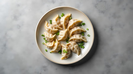 Plate with tasty dumplings on light background, top viewの素材