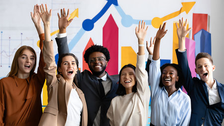 Cheerful multiethnic business people raising hands up in officeの素材