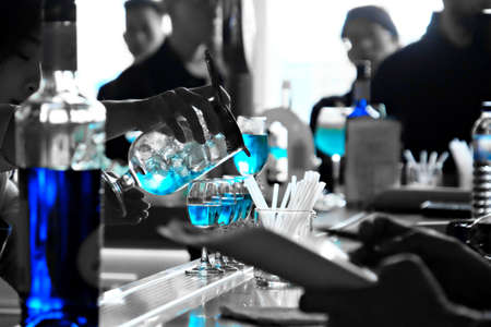 Bartender making bright blue cocktailsの写真素材