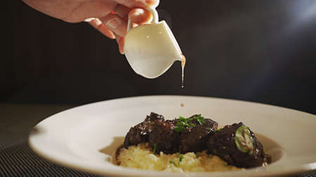 The moment the sauce is poured over the beef risottoの写真素材