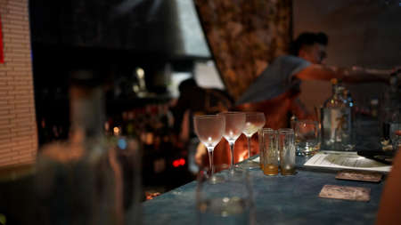 Nightlife in the bar, empty glass on the bar counterの写真素材