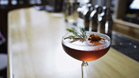 At the bar in the afternoon, the sun shines on a red drinkの写真素材