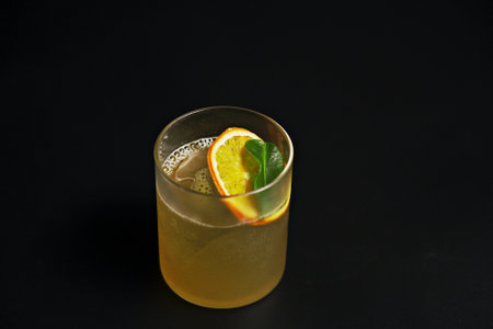 A glass of fruit drink on a black backgroundの写真素材