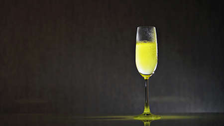 A glass of golden champagne cocktailの写真素材