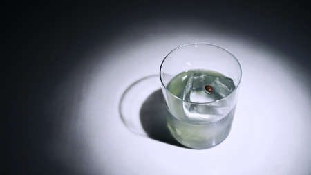 A glass of grey drink with coffee beansの写真素材