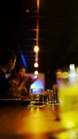 A glass of whiskey on the barの写真素材