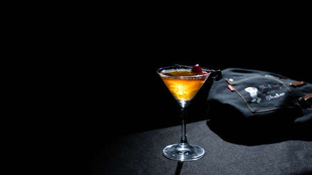 A glass of Manhattan cocktail on a black backgroundの写真素材