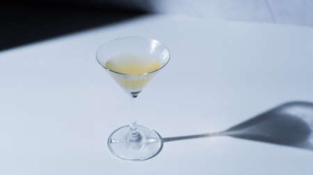 Light and shadow of a cocktail on a white countertopの写真素材