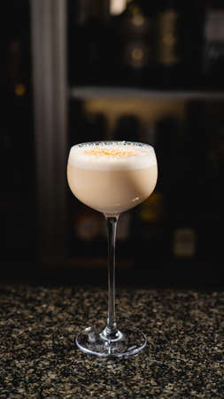 A glass of cream cocktail on a marble barの写真素材