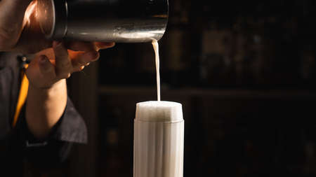 The moment the bartender makes a Ramos gin fizz cocktailの写真素材