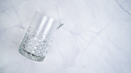 Mixing glass on white marble backgroundの写真素材