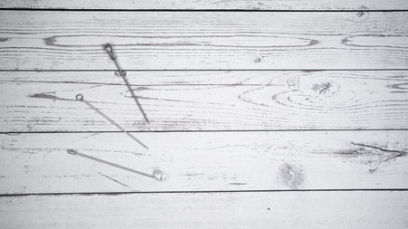 Three metal fruit fork on white wooden backgroundの写真素材